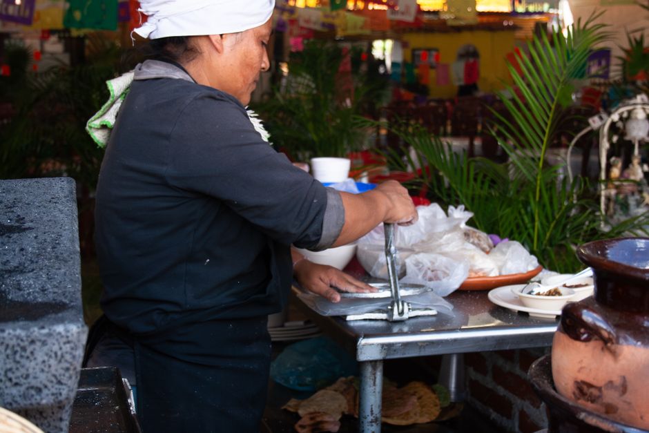 Hand-pressing fresh tortillas